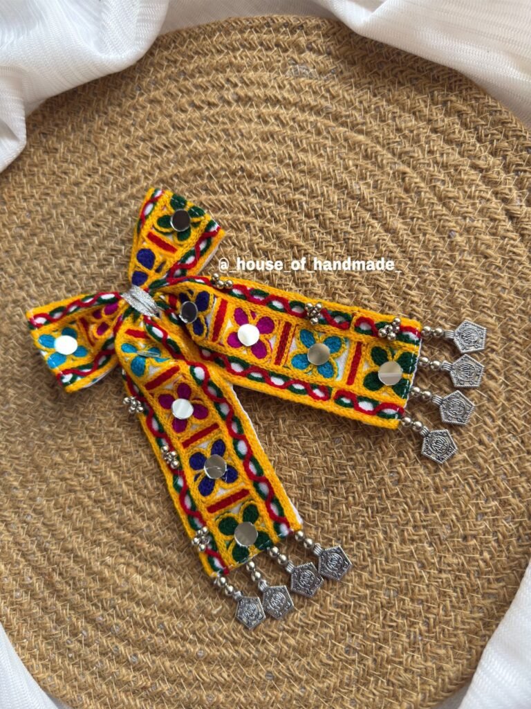 Handmade Navratri hair bow with colorful Kutchi embroidery, mirror work, and cowrie shells – festive traditional hair accessory